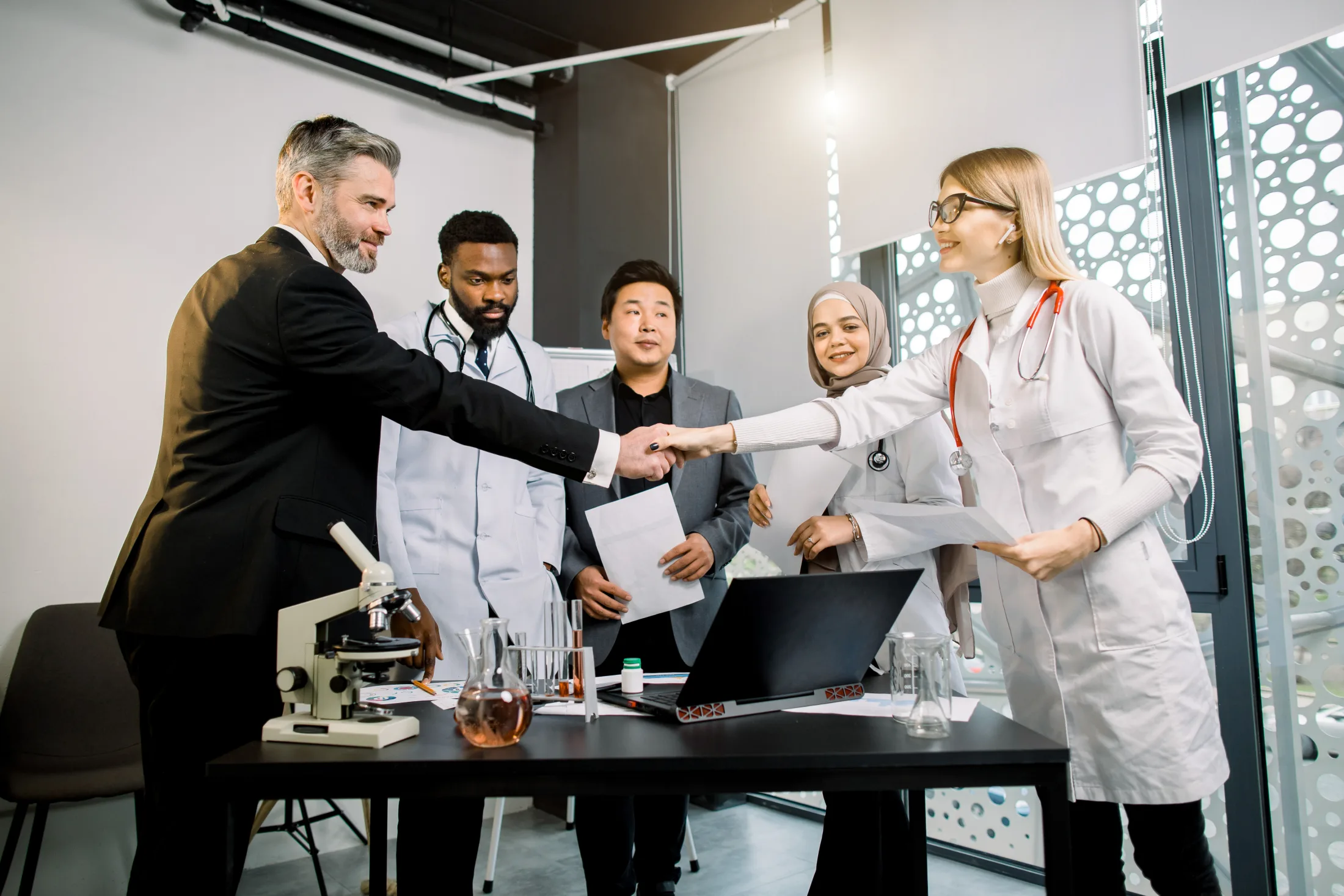 Health professionals and business leaders collaborating in a laboratory